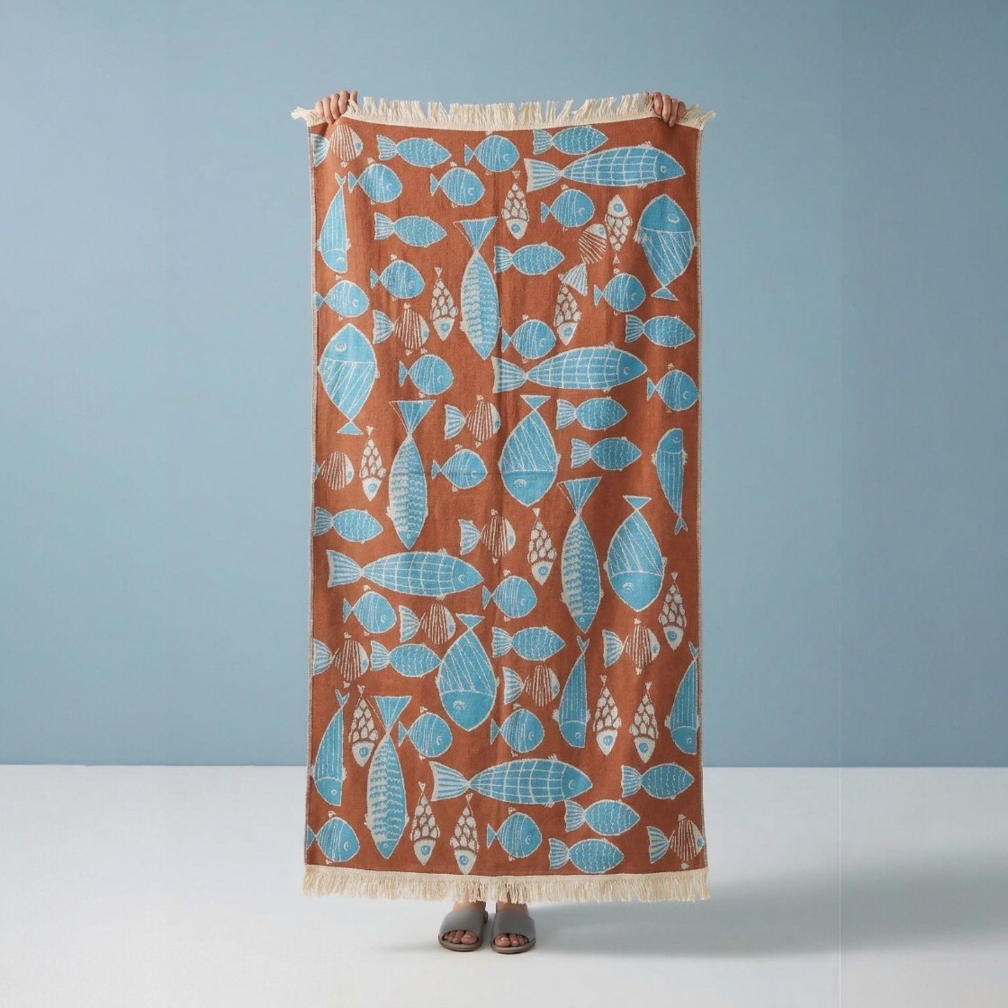 Fish Pattern 3-Layer Turkish Towel – Jacquard Woven Muslin Beach Towel on a brown background