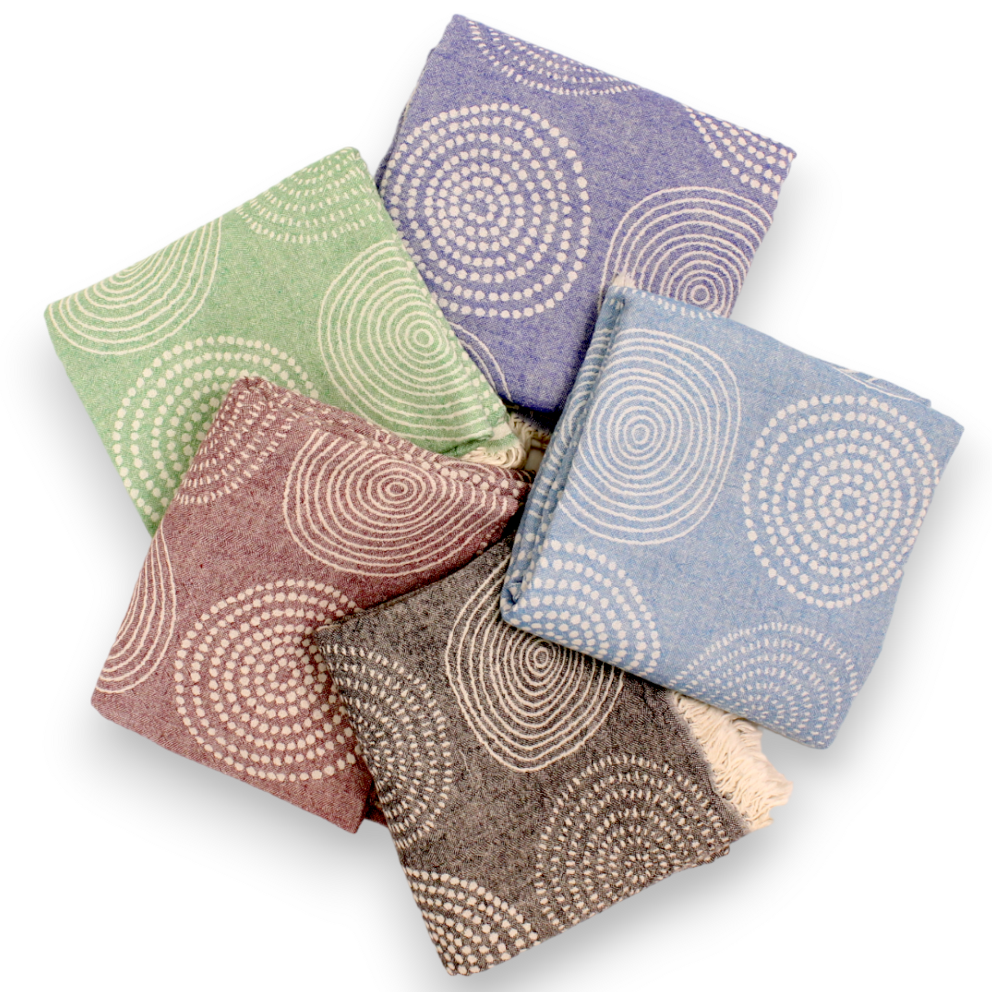 A collection of handwoven natural cotton towels with geometric patterns, including stripes and mandala-inspired designs, in various natural colors.