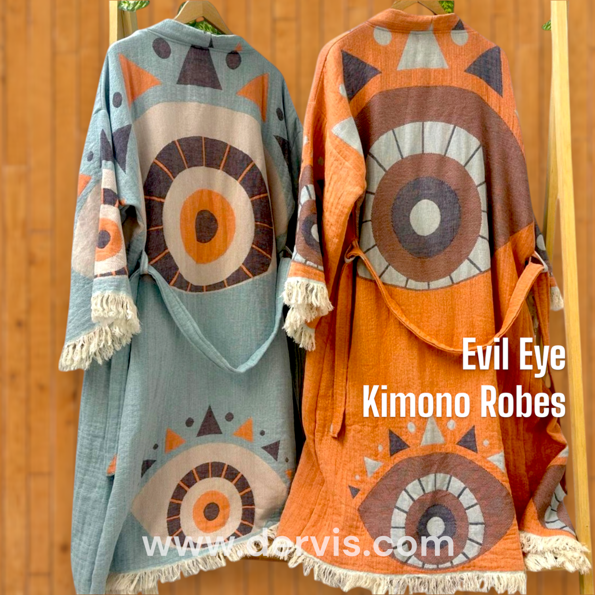 Two kimono robes with Evil Eye patterns in orange and blue colors, displayed on hangers.